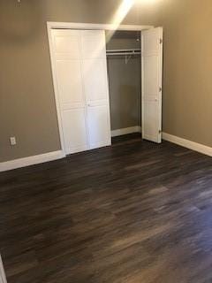 362 W Ave, Harahan, LA 70123 - unfurnished bedroom with a closet, dark wood-style flooring, and baseboards