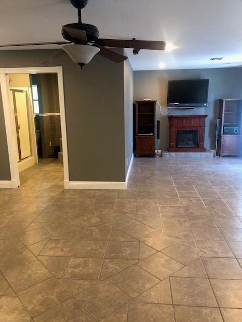 362 W Ave, Harahan, LA 70123 - unfurnished living room featuring tile patterned flooring, baseboards, a ceiling fan, and a fireplace with raised hearth