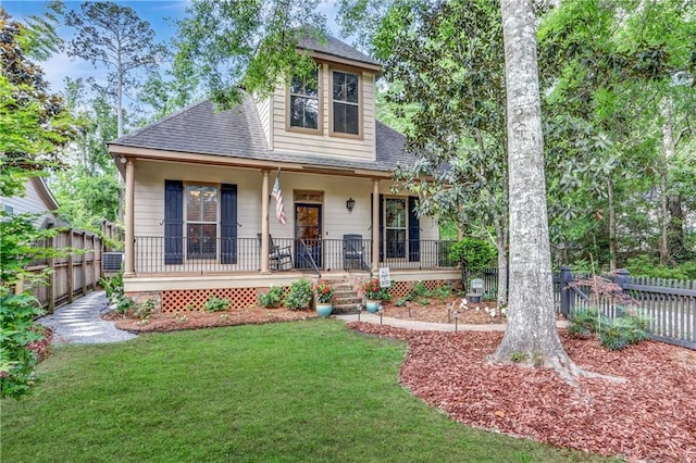 929 W 17th Ave, Covington, LA 70433 - view of front of home with covered porch, cooling unit, a shingled roof, a front lawn, and fence private yard