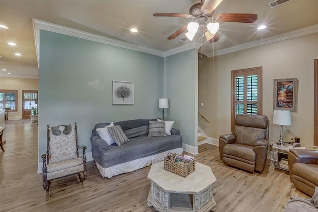 929 W 17th Ave, Covington, LA 70433 - living room with baseboards, light wood finished floors, ceiling fan, and plenty of natural light