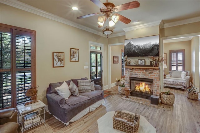 929 W 17th Ave, Covington, LA 70433 - living room featuring baseboards, ornamental molding, ceiling fan, a brick fireplace, and wood finished floors