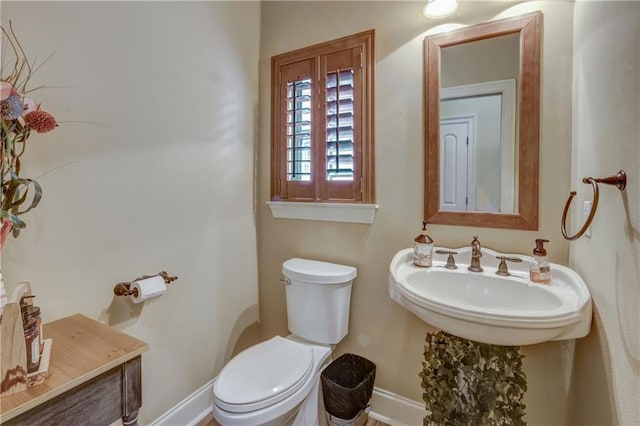 929 W 17th Ave, Covington, LA 70433 - half bathroom with toilet, baseboards, and a sink