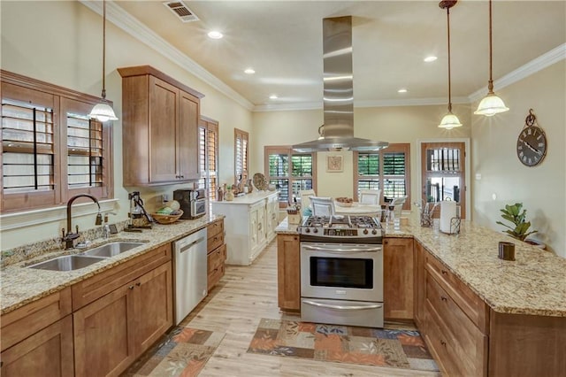 929 W 17th Ave, Covington, LA 70433 - kitchen with light wood-style flooring, visible vents, a sink, island range hood, and stainless steel appliances