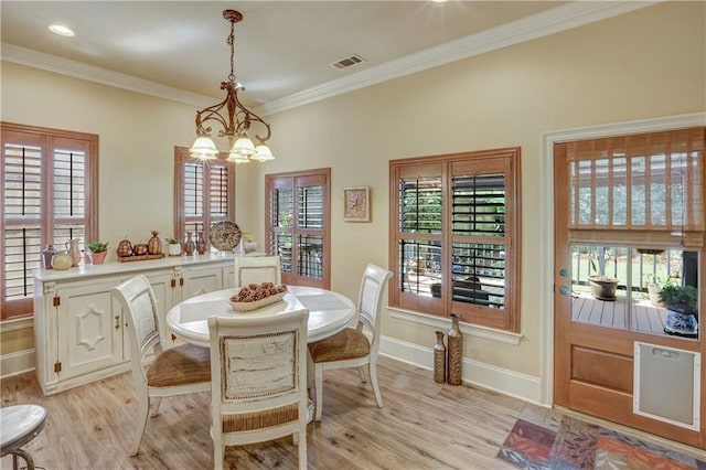 929 W 17th Ave, Covington, LA 70433 - dining area featuring an inviting chandelier, light wood-style flooring, baseboards, and a healthy amount of sunlight
