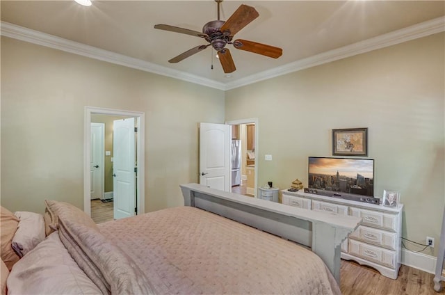 929 W 17th Ave, Covington, LA 70433 - bedroom featuring light wood finished floors, freestanding refrigerator, baseboards, ceiling fan, and ornamental molding