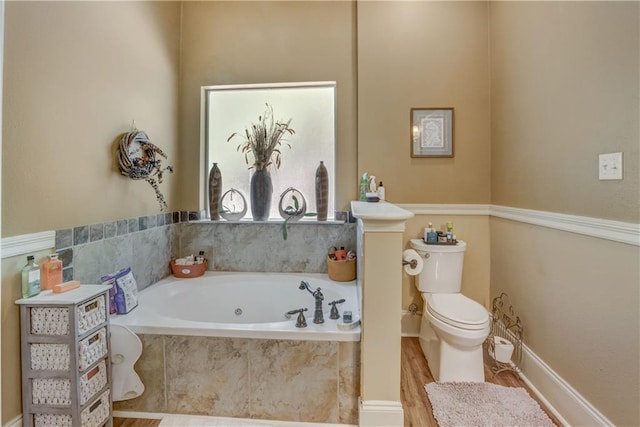 929 W 17th Ave, Covington, LA 70433 - full bathroom featuring toilet, a bath, and wood finished floors