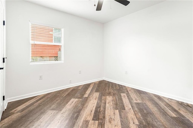 empty room with a ceiling fan, baseboards, and wood finished floors