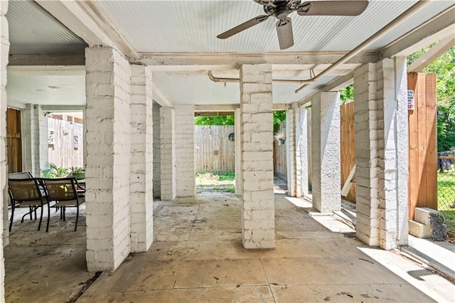 view of patio featuring outdoor dining area, fence, and ceiling fan