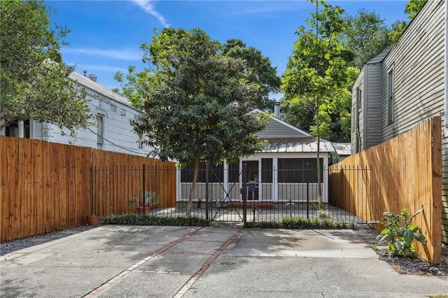 back of property with a gate and fence private yard