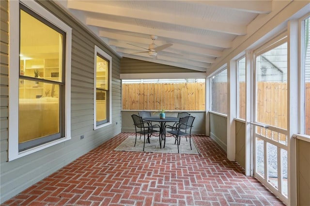 sunroom with beamed ceiling, outdoor dining area, and ceiling fan