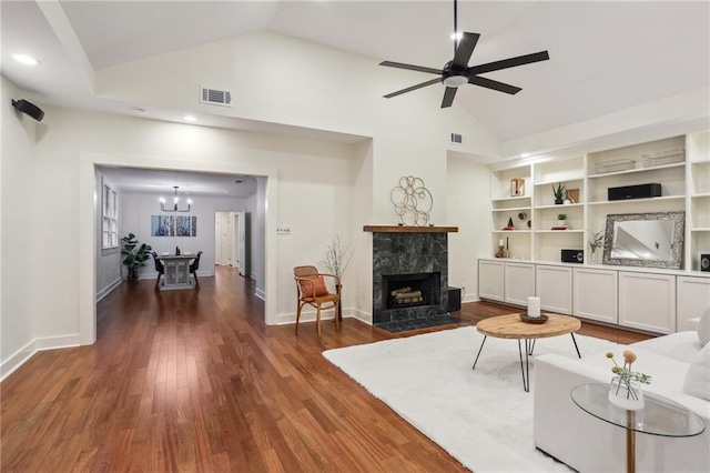 living area featuring visible vents, a fireplace, dark wood-type flooring, and high vaulted ceiling