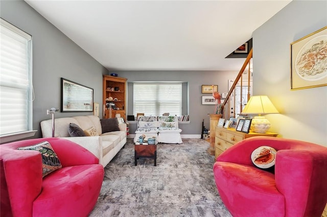 living room with stairway, carpet floors, and baseboards