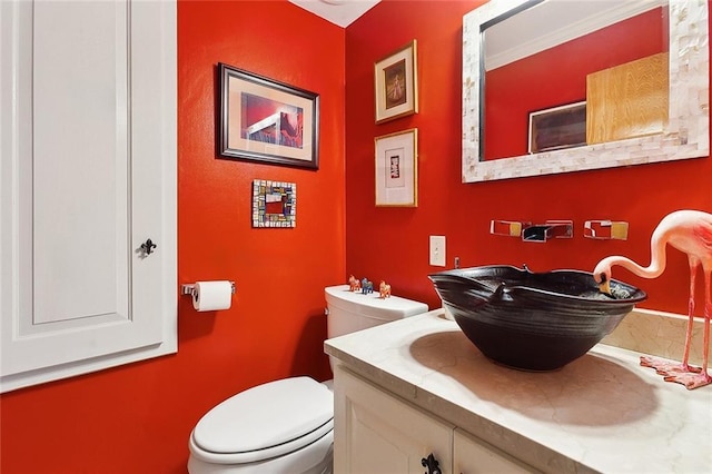 half bathroom featuring toilet and vanity