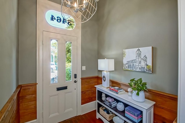 foyer with a chandelier and dark wood-type flooring