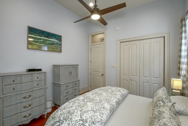 bedroom featuring a closet, dark wood-type flooring, and ceiling fan