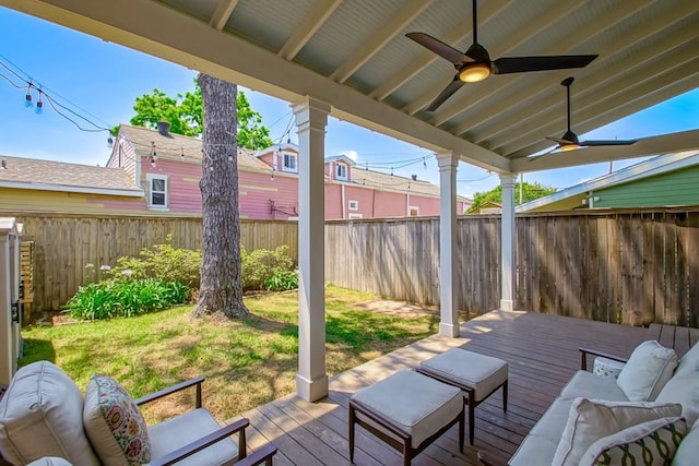 wooden deck with a fenced backyard, a ceiling fan, and outdoor lounge area