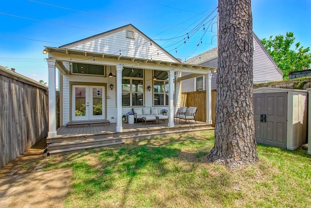 back of property featuring an outdoor hangout area, a deck, french doors, ceiling fan, and a storage unit