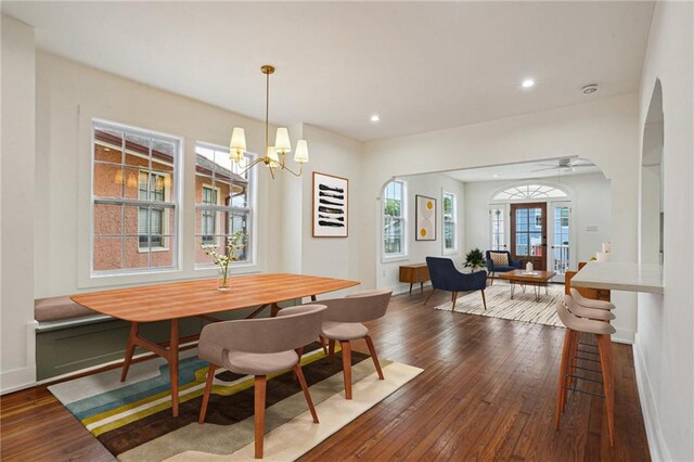 925 Picheloup Pl, New Orleans, LA 70119 - unfurnished living room featuring dark wood finished floors, a chandelier, recessed lighting, and arched walkways