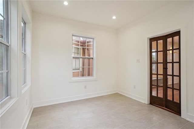 spare room with french doors, recessed lighting, baseboards, and light tile patterned floors