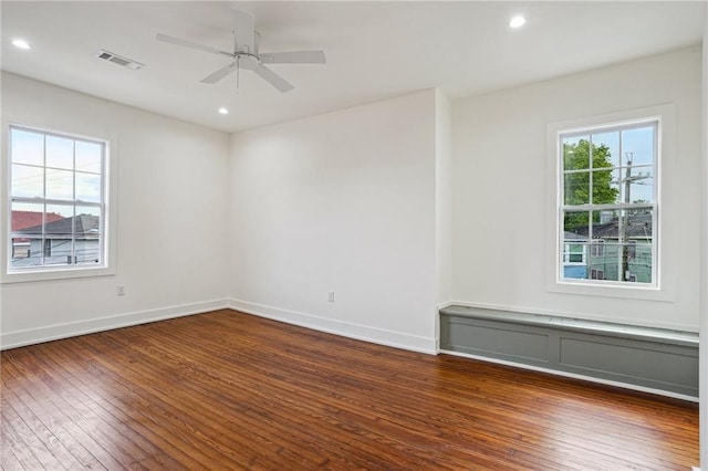 empty room with dark wood-style flooring, ceiling fan, baseboards, and recessed lighting