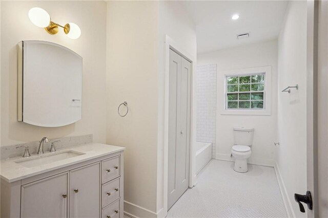 full bath with vanity, toilet, and baseboards