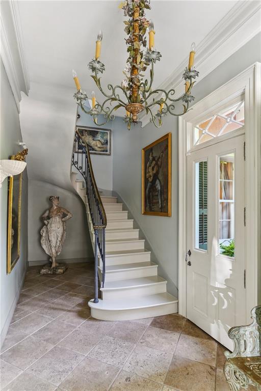 600 Governor Nicholls St, New Orleans, LA 70116 - foyer entrance with stone tile floors, crown molding, stairway, and baseboards