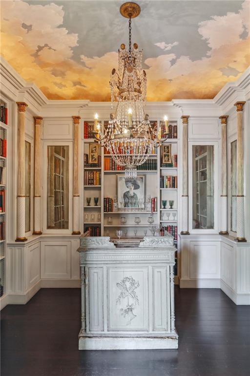 600 Governor Nicholls St, New Orleans, LA 70116 - bar area featuring a chandelier, dark wood-style flooring, hanging light fixtures, and crown molding