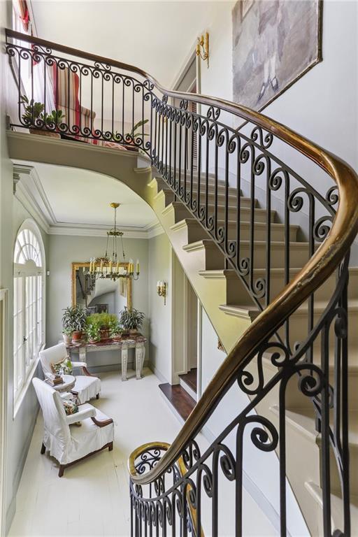 600 Governor Nicholls St, New Orleans, LA 70116 - staircase with ornamental molding, baseboards, and a high ceiling