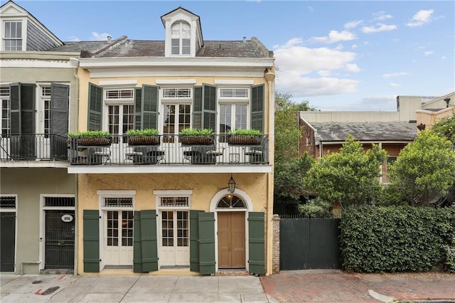 view of property with a balcony and stucco siding