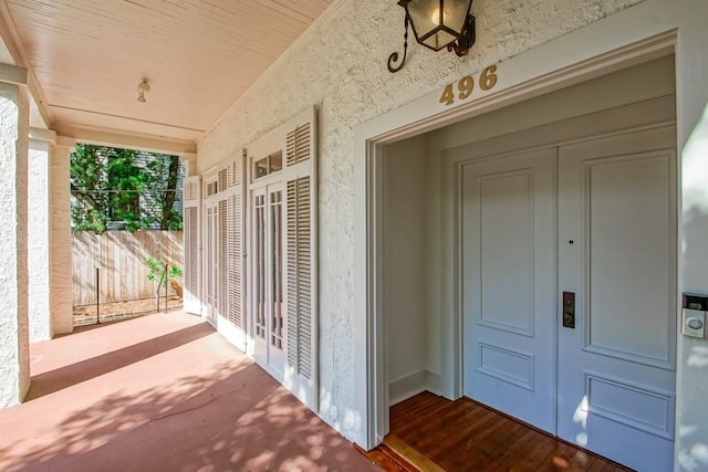 entrance to property with fence and french doors