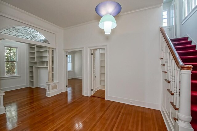 unfurnished dining area with a wealth of natural light, ornamental molding, and stairway