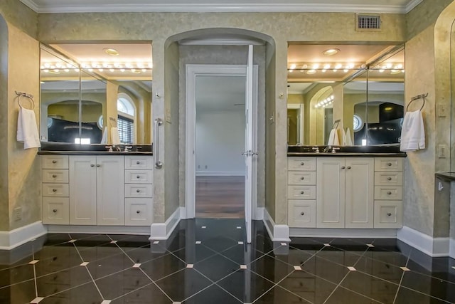 full bath featuring vanity, ornamental molding, visible vents, tile patterned flooring, and baseboards