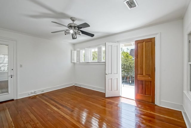 interior space featuring ceiling fan, wood-type flooring, and visible vents