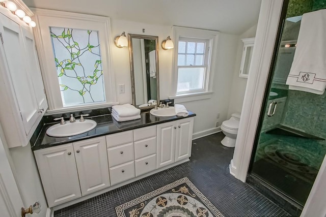 full bathroom with a sink, double vanity, toilet, and tile patterned flooring