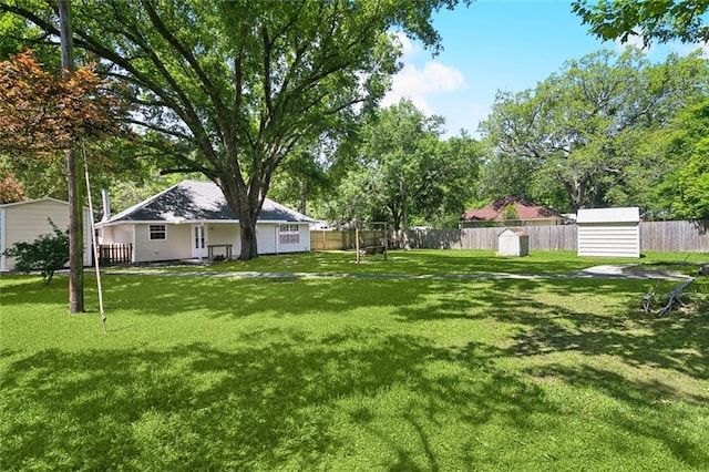 27155 Tag A Long Rd, Lacombe, LA 70445 - view of yard featuring an outdoor structure, a fenced backyard, and a shed