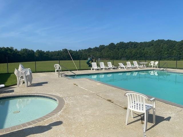 400 Brown Thrasher Loop, Madisonville, LA 70447 - community pool featuring a patio and a view of trees