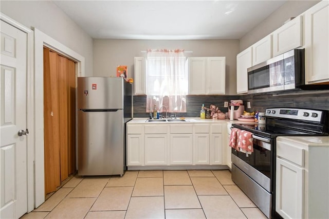 3619-25 Delachaise St, New Orleans, LA 70125 - kitchen featuring a sink, backsplash, white cabinetry, and appliances with stainless steel finishes