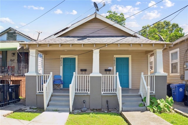 3619-25 Delachaise St, New Orleans, LA 70125 - bungalow featuring covered porch and roof with shingles
