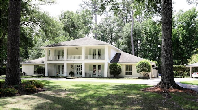72 Riverdale Dr, Covington, LA 70433 - back of house featuring french doors, a yard, a balcony, and view of wooded area