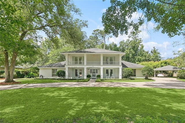 72 Riverdale Dr, Covington, LA 70433 - view of front of property with french doors, a front lawn, a balcony, and a carport