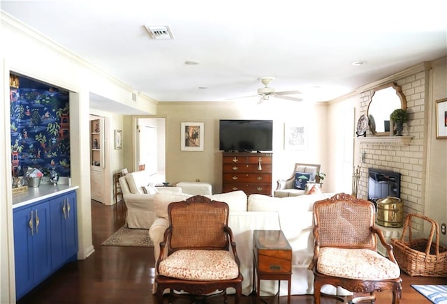 72 Riverdale Dr, Covington, LA 70433 - living room featuring a ceiling fan, dark wood-style floors, crown molding, and a brick fireplace