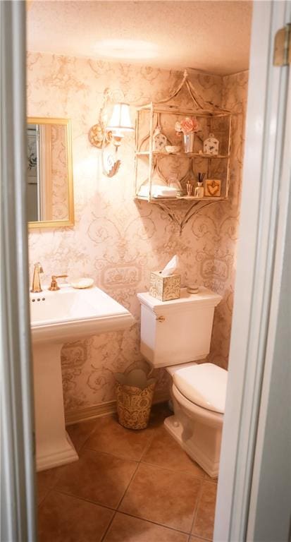 72 Riverdale Dr, Covington, LA 70433 - half bath with tile patterned floors, toilet, and wallpapered walls