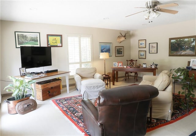 living area with a ceiling fan and carpet floors