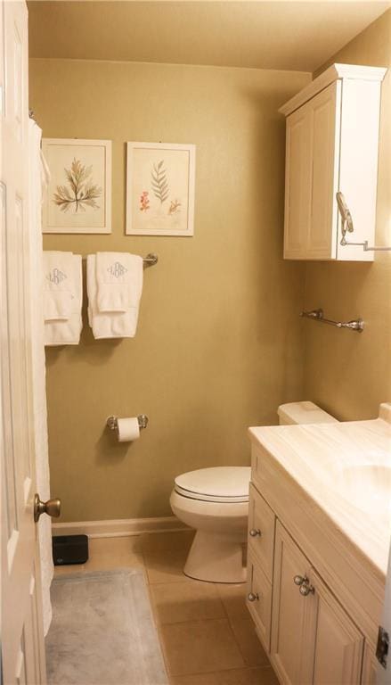 full bath featuring toilet, baseboards, tile patterned floors, and vanity