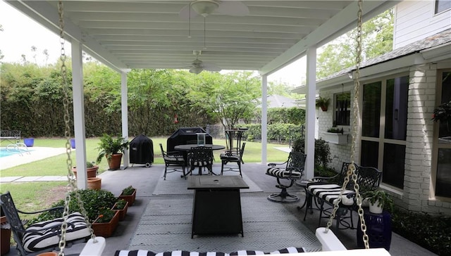 view of patio / terrace with outdoor dining space, a ceiling fan, and an outdoor pool
