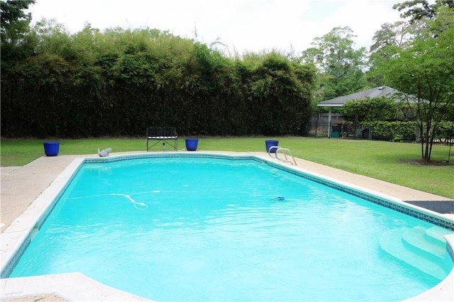 72 Riverdale Dr, Covington, LA 70433 - outdoor pool with a lawn and view of scattered trees