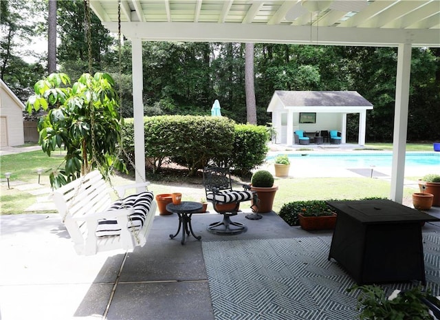 72 Riverdale Dr, Covington, LA 70433 - view of patio / terrace featuring an outbuilding, a storage structure, and an outdoor pool