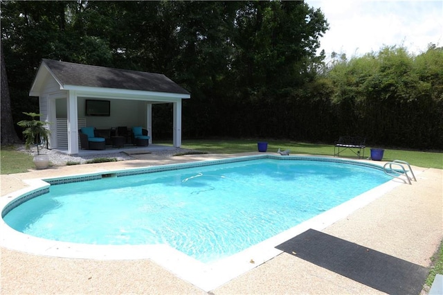 72 Riverdale Dr, Covington, LA 70433 - swimming pool featuring an outdoor structure, a storage structure, and a patio