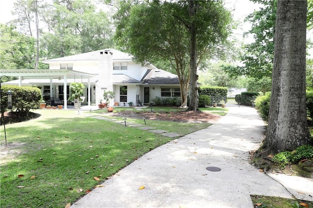 view of front of property featuring a pergola, a patio, a gate, and a front yard