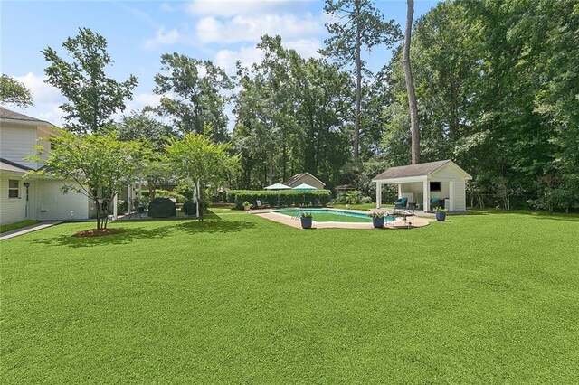 72 Riverdale Dr, Covington, LA 70433 - swimming pool featuring a lawn and view of scattered trees